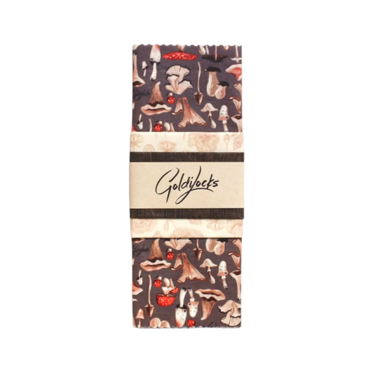 A package of Goldilocks reusable beeswax food wraps featuring a mushroom pattern on a brown background with a minimal band design.